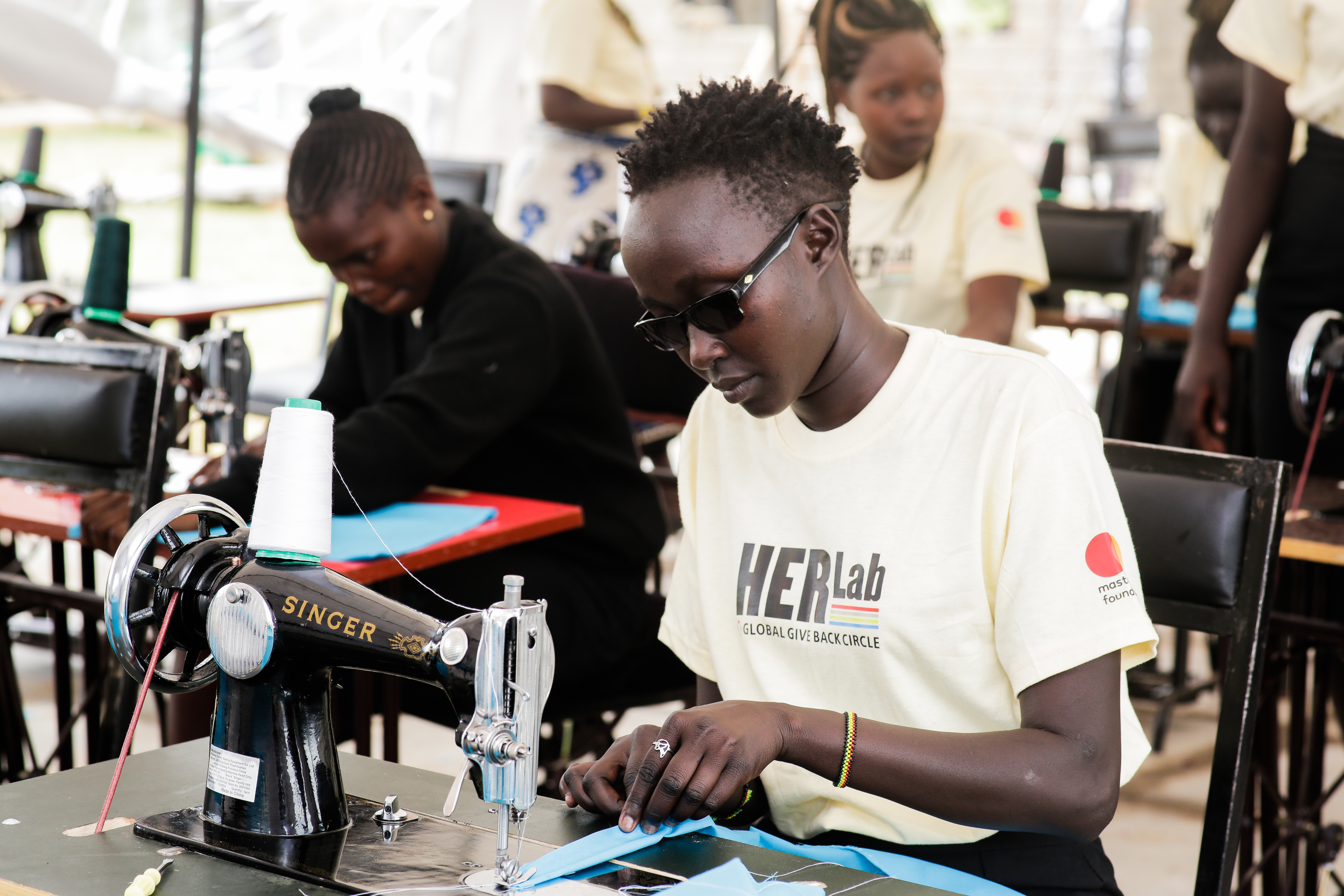 Female students collaborating on innovative technology projects at the HER Lab, demonstrating women's engagement in STEM education and digital skills development